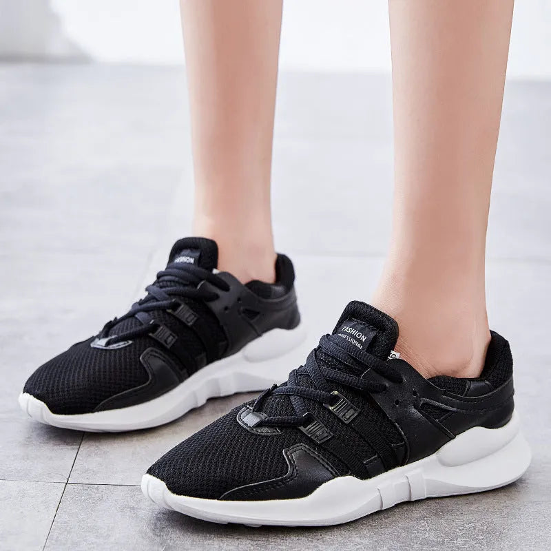 Breathable hollow mesh sneakers in black and white colours with round toe design