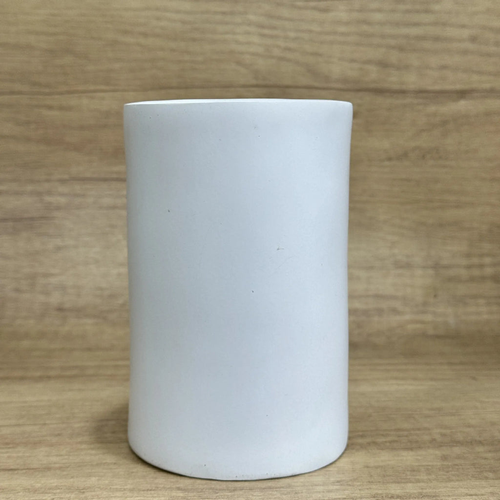 A fun-coloured resin decorative holder for a tissue box, shown on a desktop.