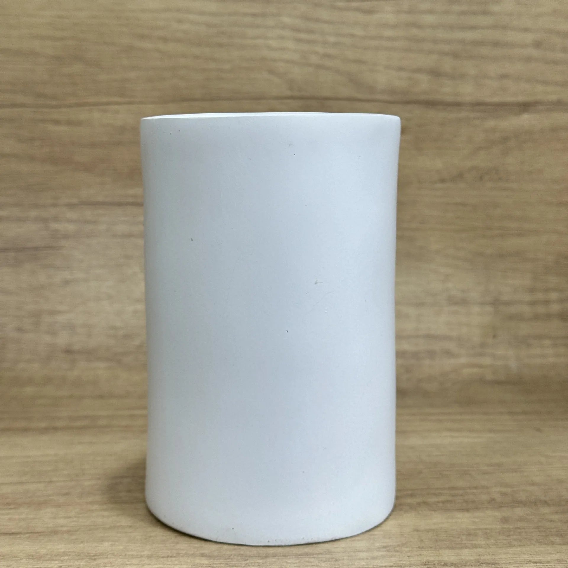 A fun-coloured resin decorative holder for a tissue box, shown on a desktop.