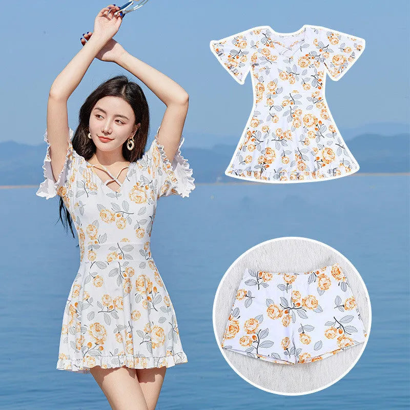 Women's high-waist one-piece swimsuit with floral print in blue and white.
