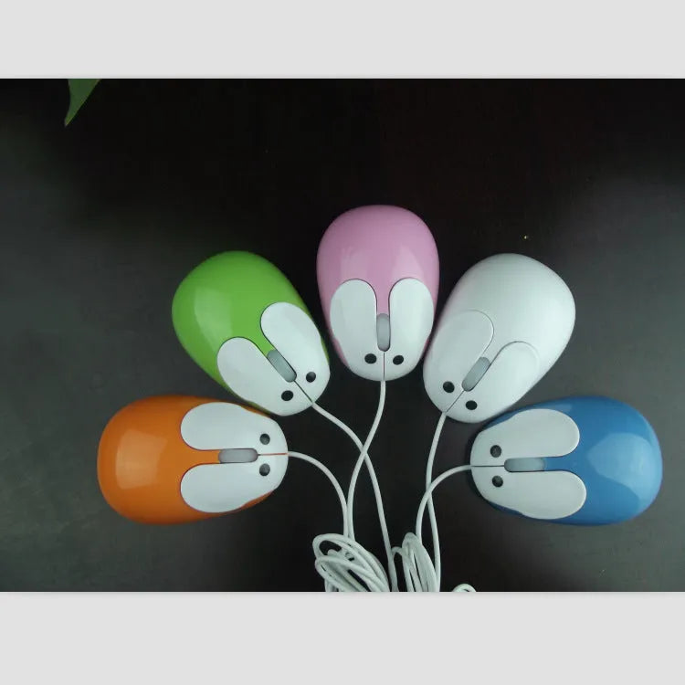Pink wired rabbit mouse on desktop with USB cable and scroll wheel
