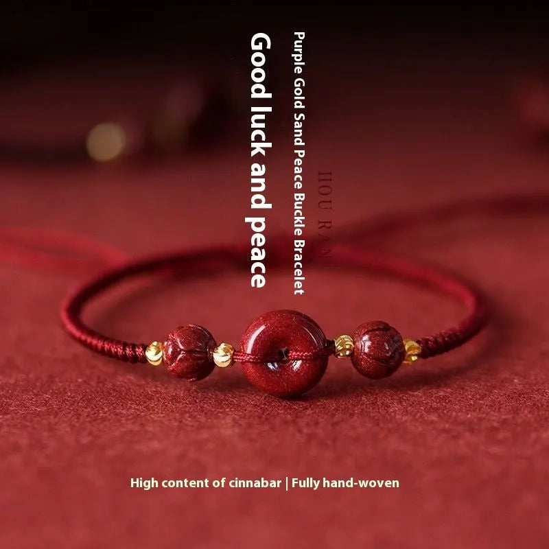 Traditional Chinese cinnabar bracelet with heart-shaped centrepiece and peace buckle clasp on coloured rope cord