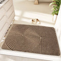 Green alien-shaped entrance mat with cartoon pattern on a wooden floor.