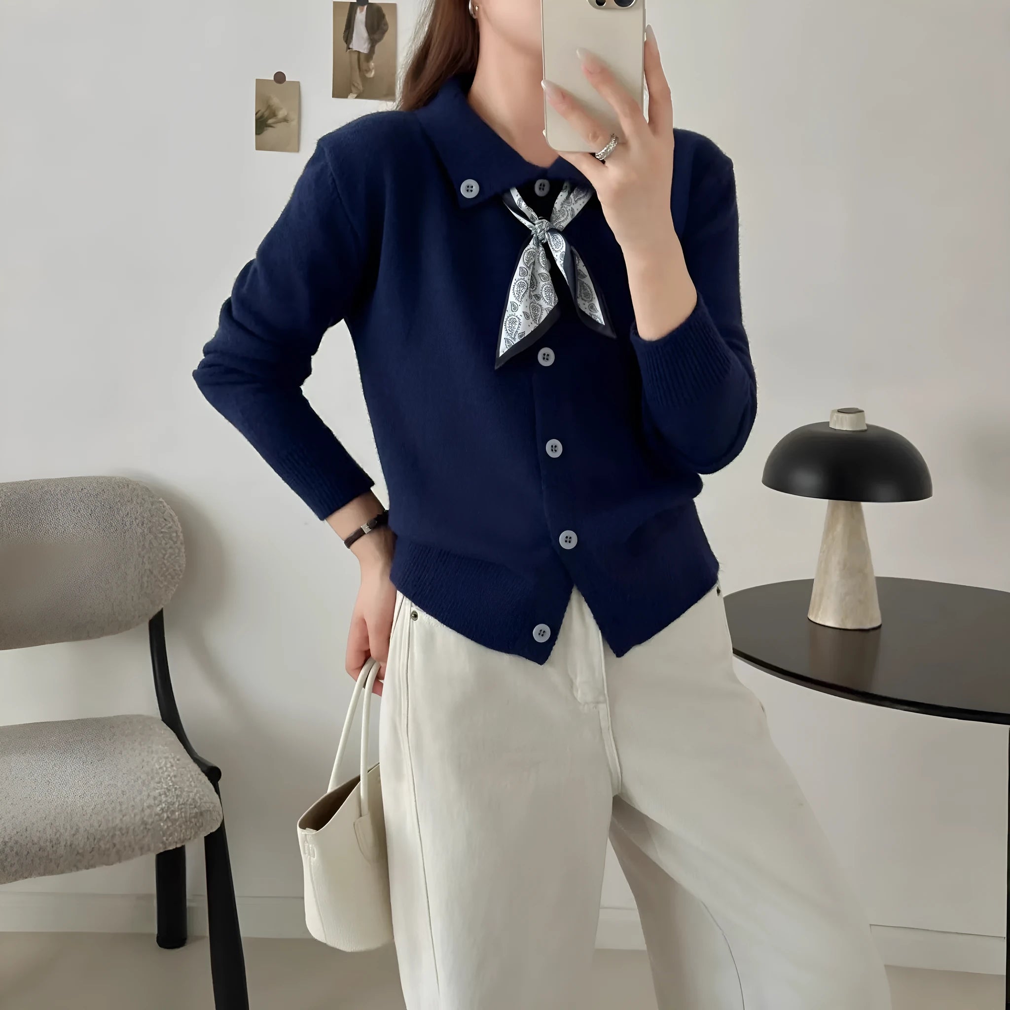 Beige lapel scarf cardigan sweater with long sleeves and splicing detail on a hanger.