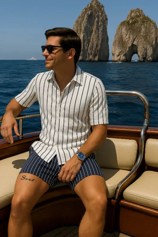 Men's light blue beach shirt and shorts set made from elastic fabric on a hanger.
