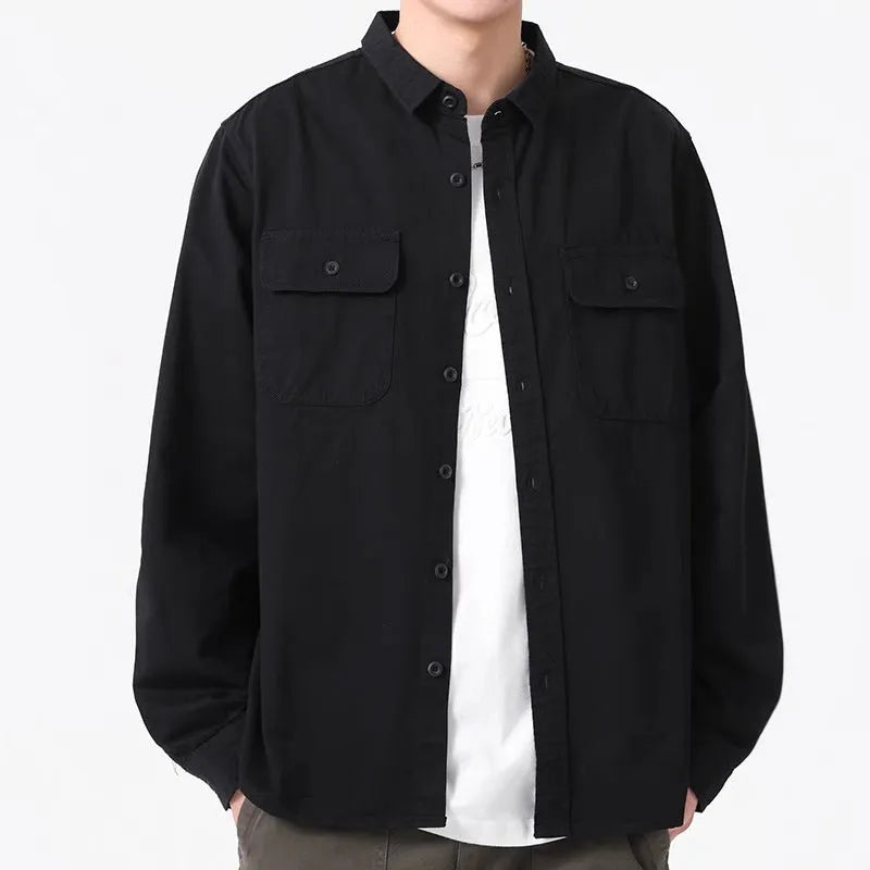 Man wearing a loose fit long sleeve cardigan shirt in light grey polyester.