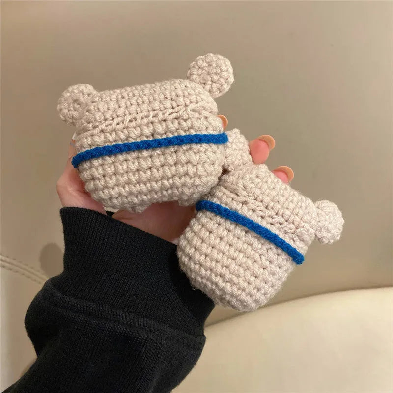 Hand-knitted grey koala bear backpack case for Apple AirPods on a wooden table.