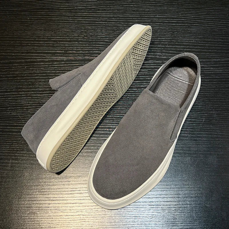 Men's casual slip-on shoes in apricot colour with round toe and mid heel, showing sewing line detail on artificial PU upper