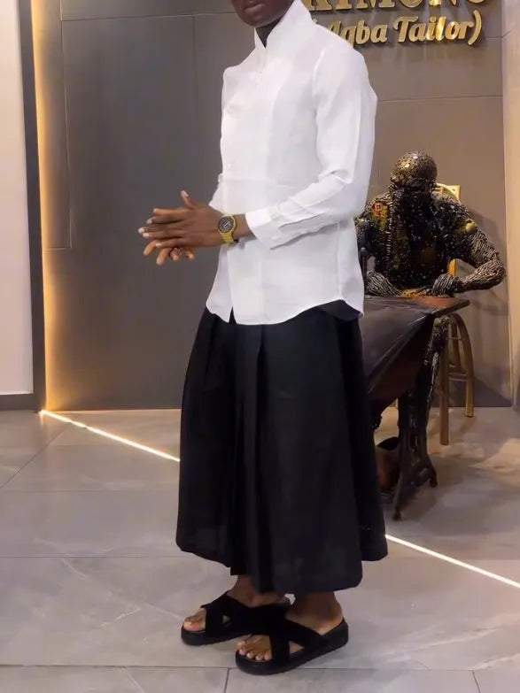 Women's white asymmetric long sleeve shirt and black pleated trousers co-ord set