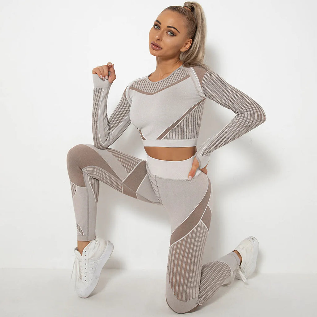 Woman wearing a seamless long-sleeved striped yoga suit in a stretch pose.