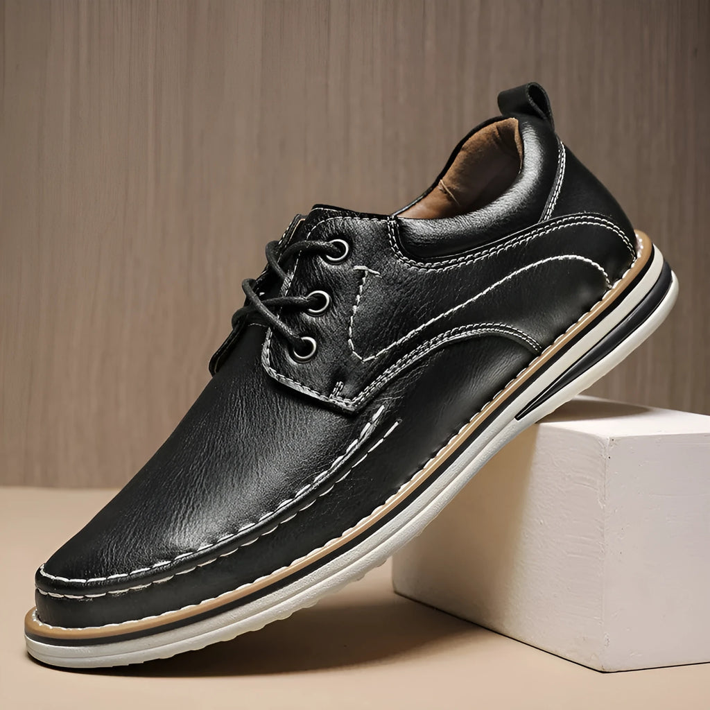 Men's genuine cowhide leather casual shoes in black with round toe and front lace-up design on a neutral background