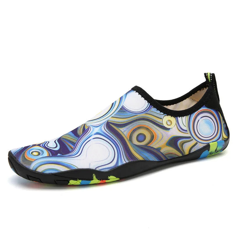 Men's and women's beach wading shoes in blue, with Lycra upper and EVA midsole, on a sandy background.