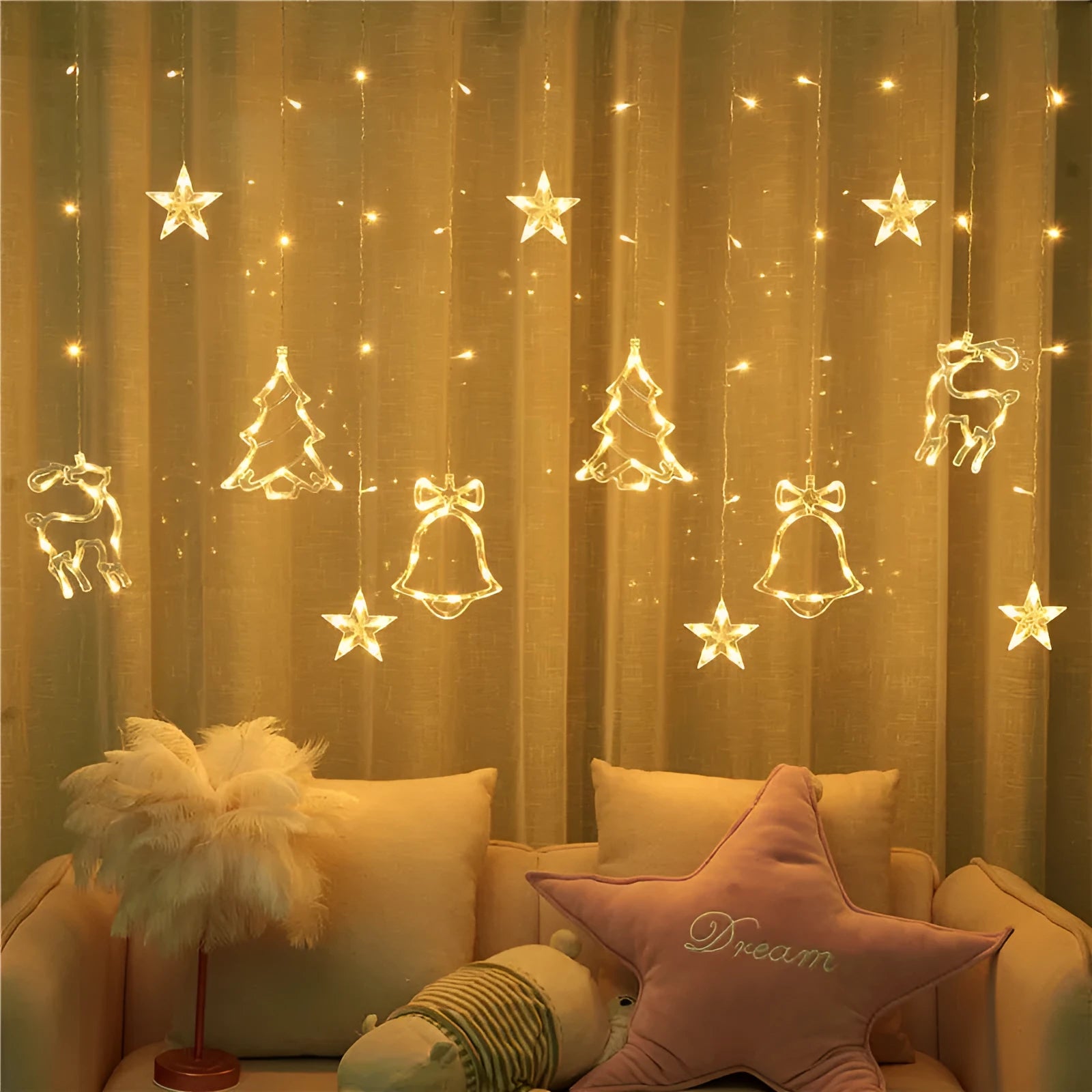 LED Christmas curtain lights with deer and tree pendants in warm white on a window