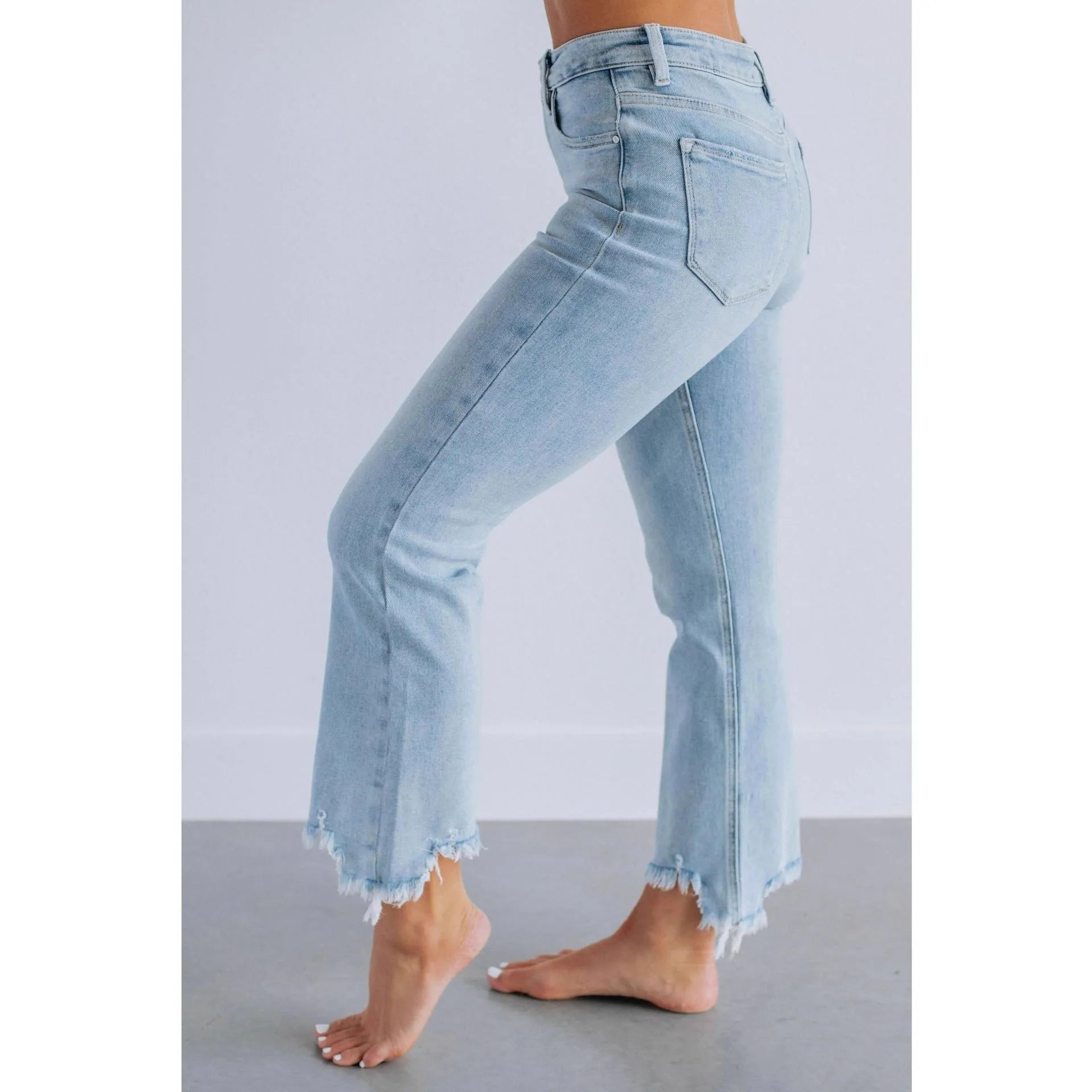 Women's solid dark blue denim casual pants with a hand-worn finish on a hanger.