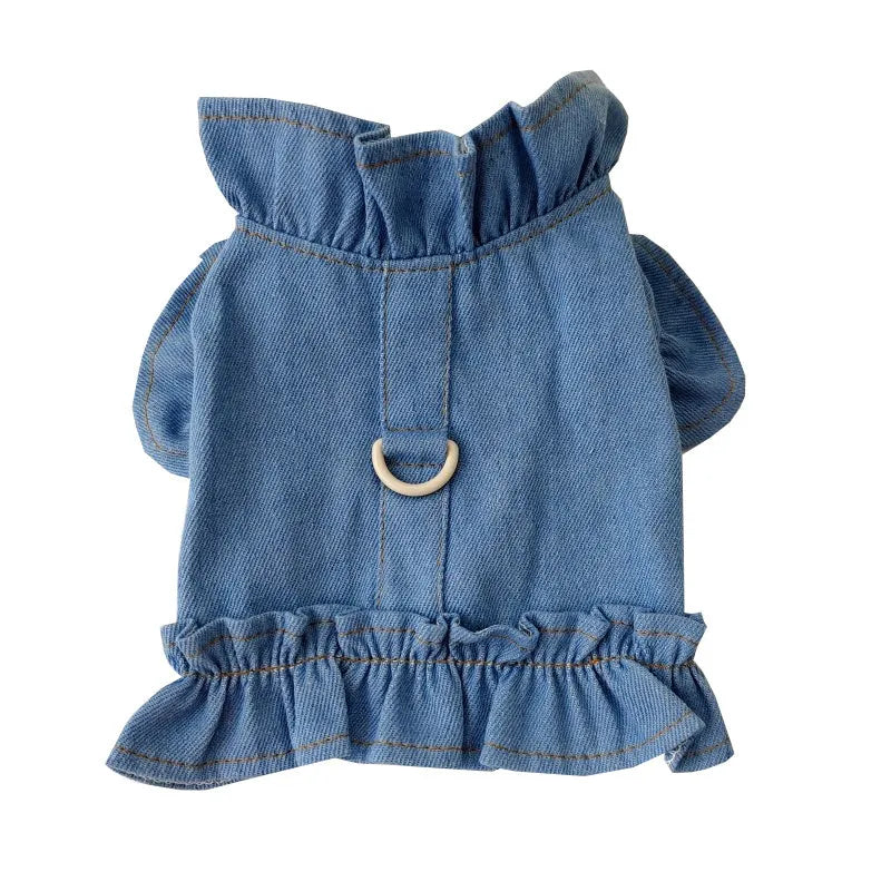 Blue denim dog dress with ruffles and a metal leash hook on the chest, shown on a small dog