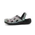 Black women's platform sandals with rhinestone detail and an open hole design on the EVA upper.