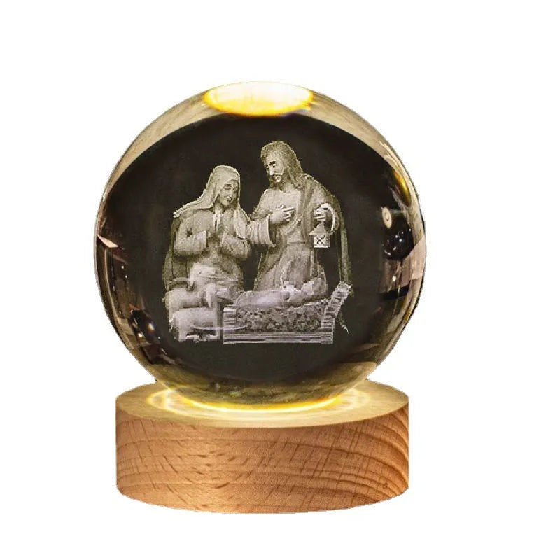 White crystal decorative ball with cross scenes on a wooden warm light base.