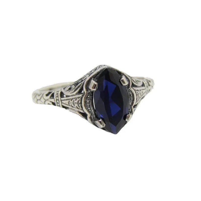 Silver geometric hollow alloy women's ring on a grey background