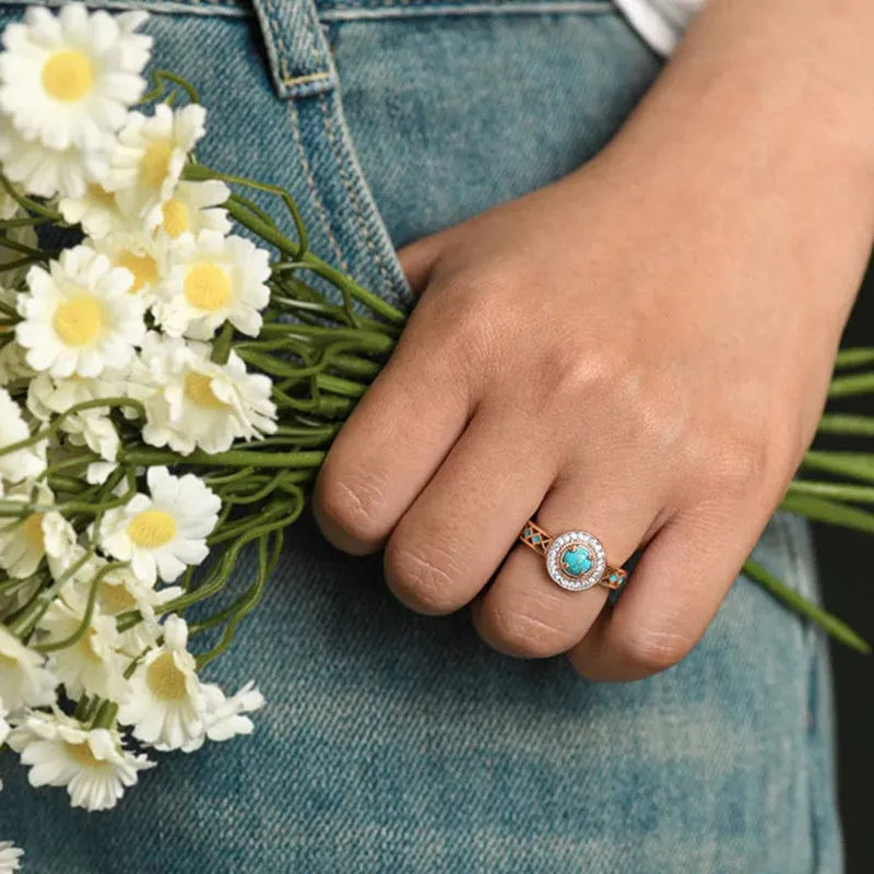 Women's geometric turquoise ring with zircon inlay on rose gold copper band, showing ethnic style design