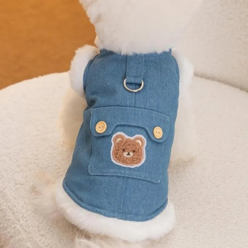 Denim blue pet vest with white wool lining, bear print, wooden buttons, and metal D-ring.