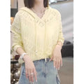 Women's blue crochet hollow hooded long-sleeve pullover top on a hanger.