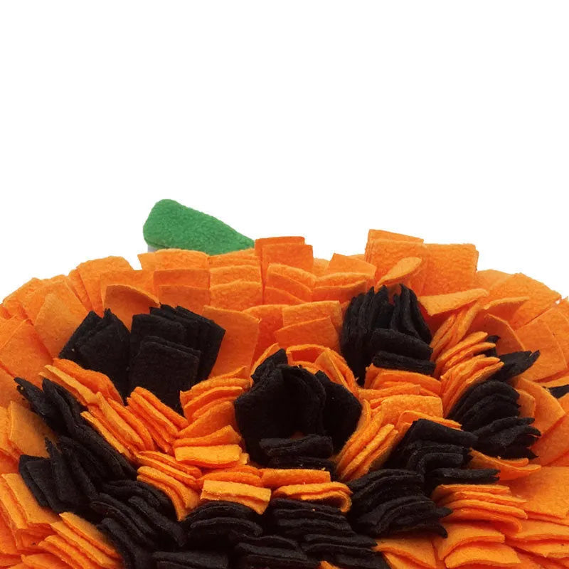 Orange pumpkin-shaped dog sniffing mat with a textured fur-like surface for slow feeding and enrichment.