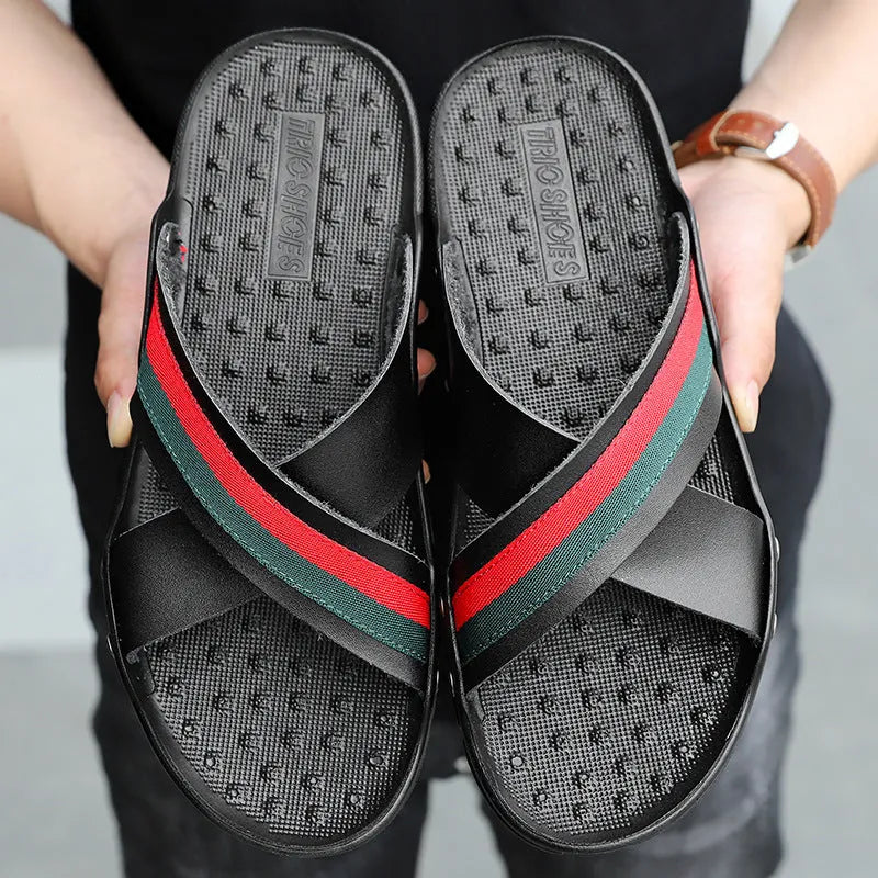 Men's leather flip-flops in black on a white background, showing cowhide upper and textured PU sole.