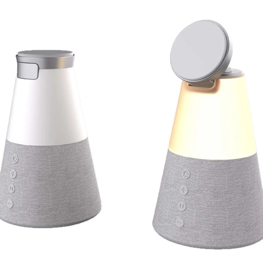 Gray 3-in-1 magnetic wireless charging Bluetooth speaker night light on a wooden table