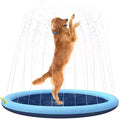 Large blue dog splash pad with textured anti-slip base on grass, with a dog playing in the shallow water.