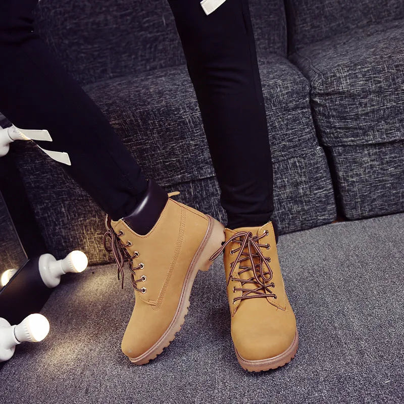 Pink men's high-top Martin boots with front laces and a round toe, showing the velvet lining.