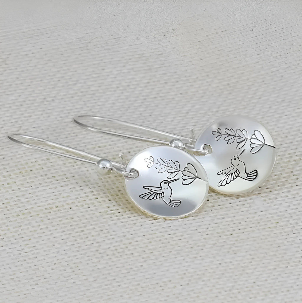 Silver zinc alloy women's earrings with glossy round bird and flower designs featuring leaf patterns