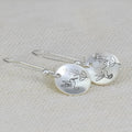 Silver zinc alloy women's earrings with glossy round bird and flower designs featuring leaf patterns