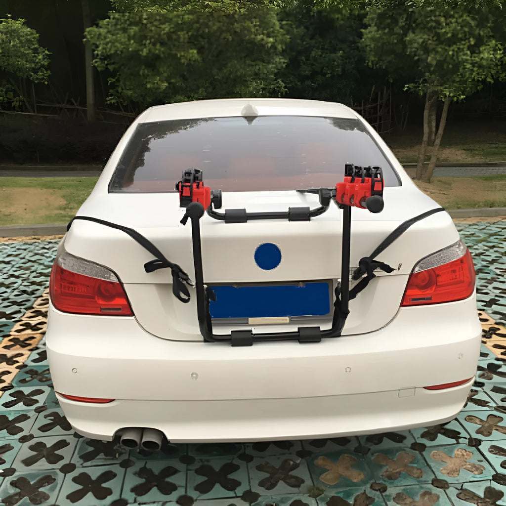 Black and red trunk mounted car bike rack with tie rope fastening, showing iron frame and sponge padding.