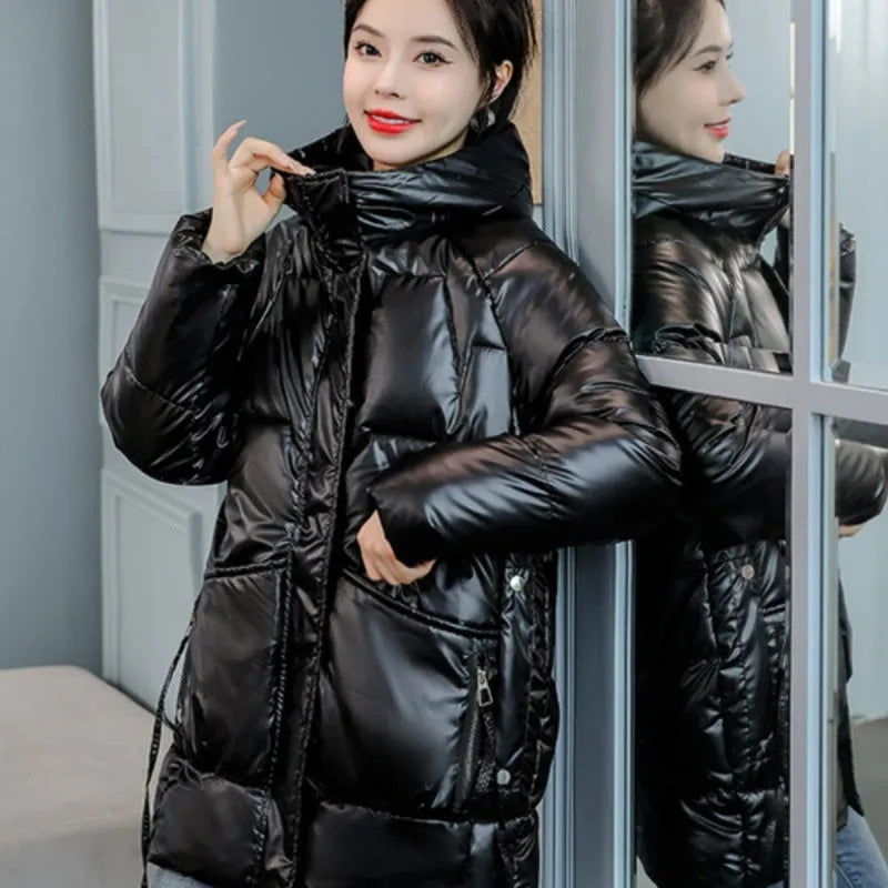 Green loose-fit hooded winter jacket for women on a hanger, showing long sleeves.