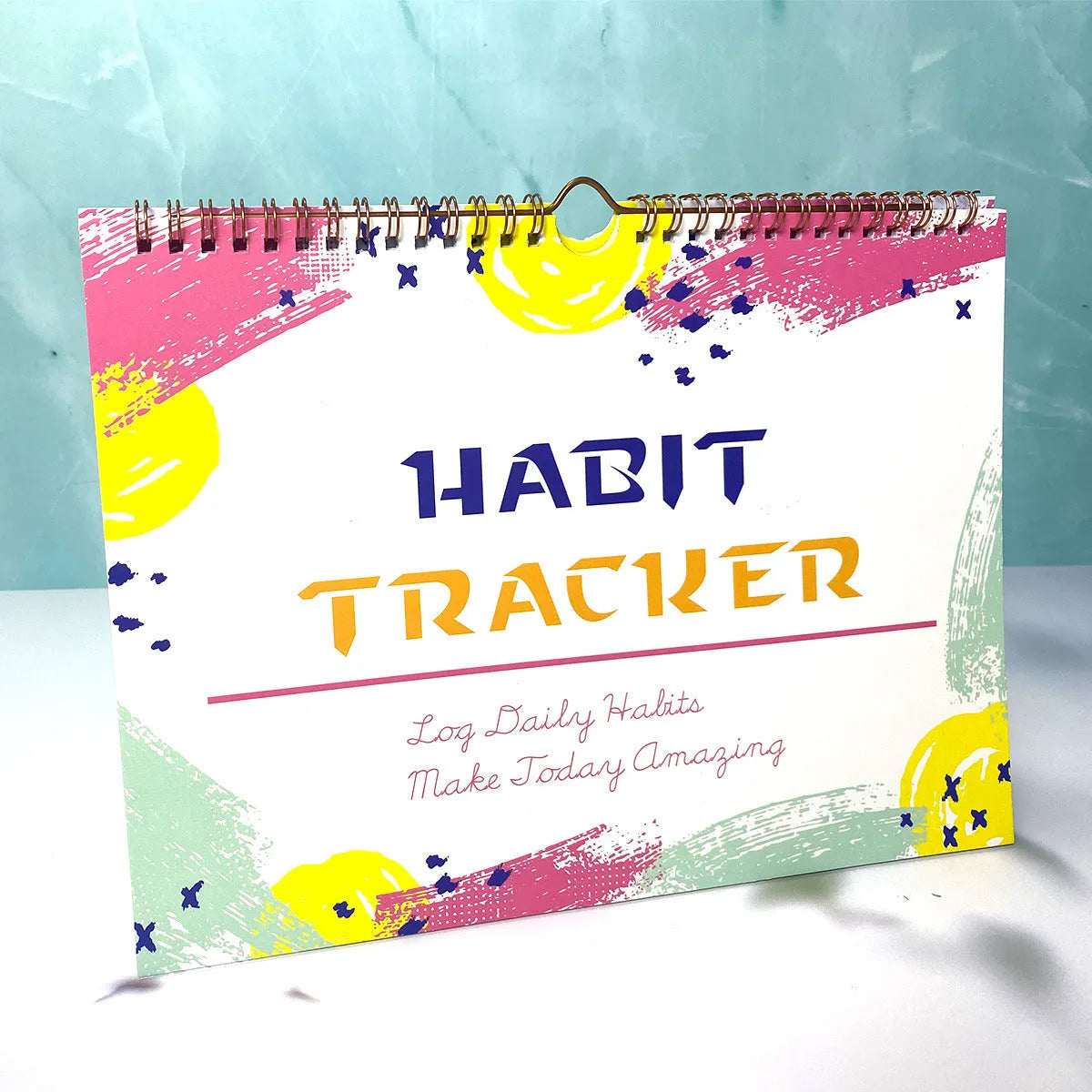 Habit tracking journal with 12 pages measuring 21cm by 28cm in four colour options