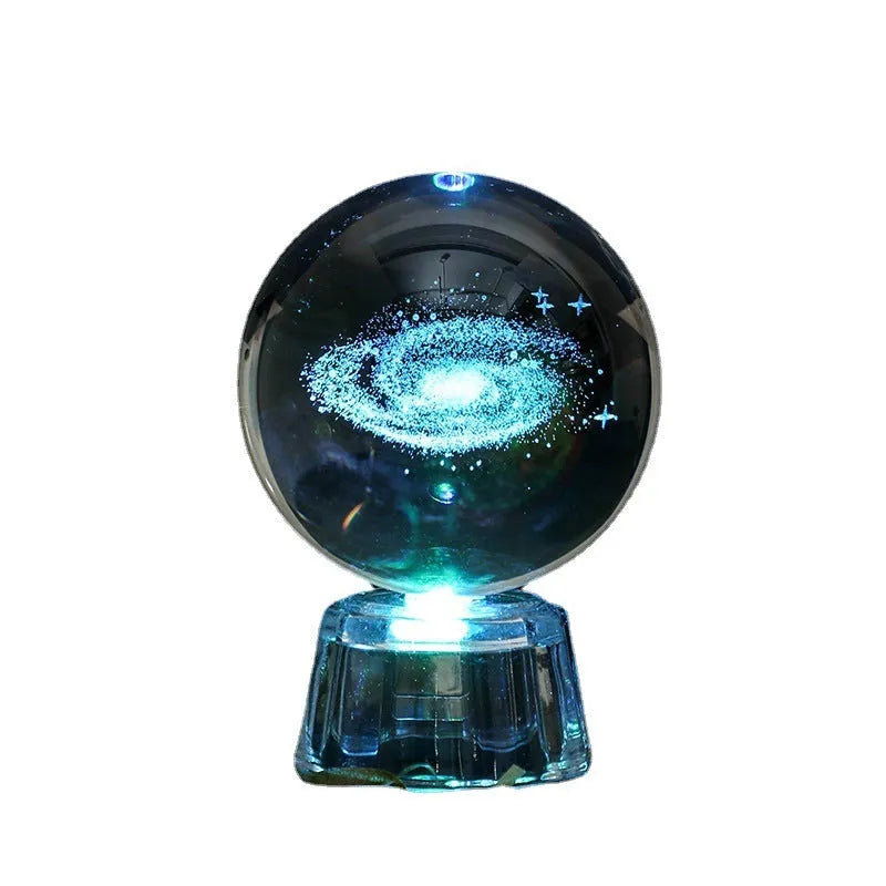 Transparent crystal ball ornament with inner carving on a table, 6cm in diameter with a modern base.