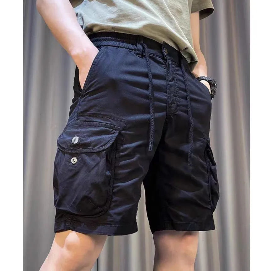 Loose straight-leg overalls pants in khaki with multiple cargo pockets on the legs.