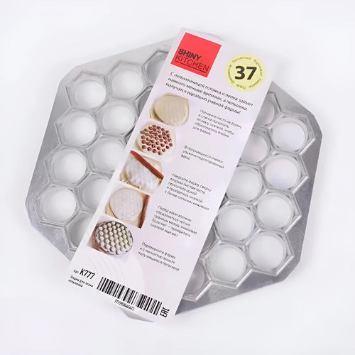 Silver aluminum alloy 37-hole dumpling mold on a plain background