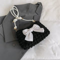 Women's black canvas one-shoulder handbag with a single strap and visible sewing thread detail