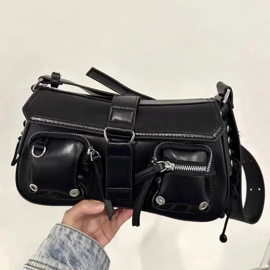 Black women's baguette style messenger bag with adjustable shoulder strap shown from front.