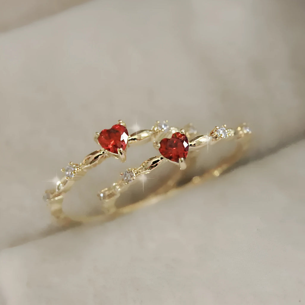 Gold or silver peach heart-shaped ring with clear zircon stones on a copper band.