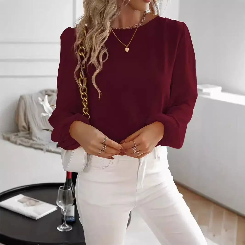 Wine red women's solid colour round neck long sleeve polyester top with button front, shown on a model.