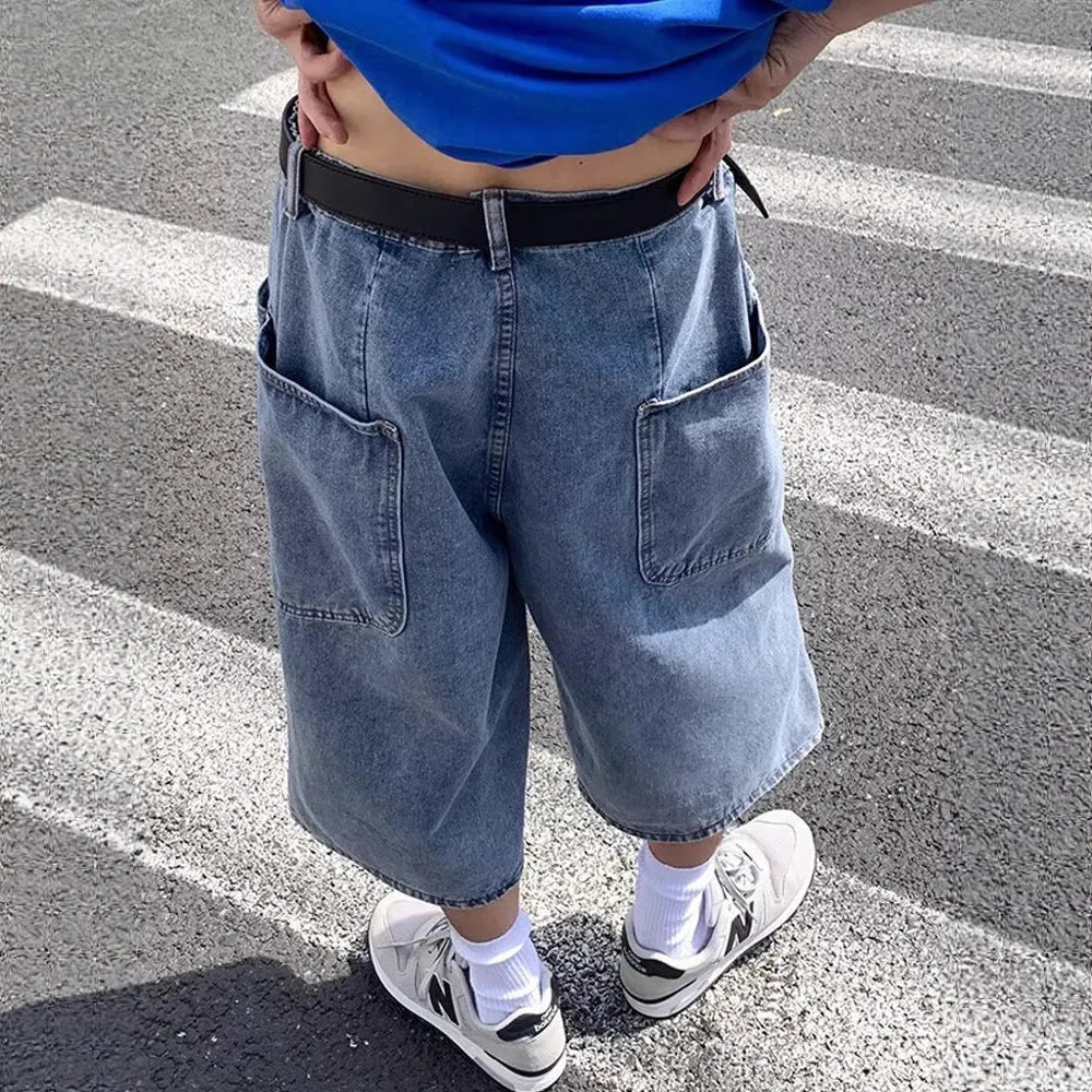 Blue men's cropped high-waisted denim-style shorts with a zipper fly on a white background.