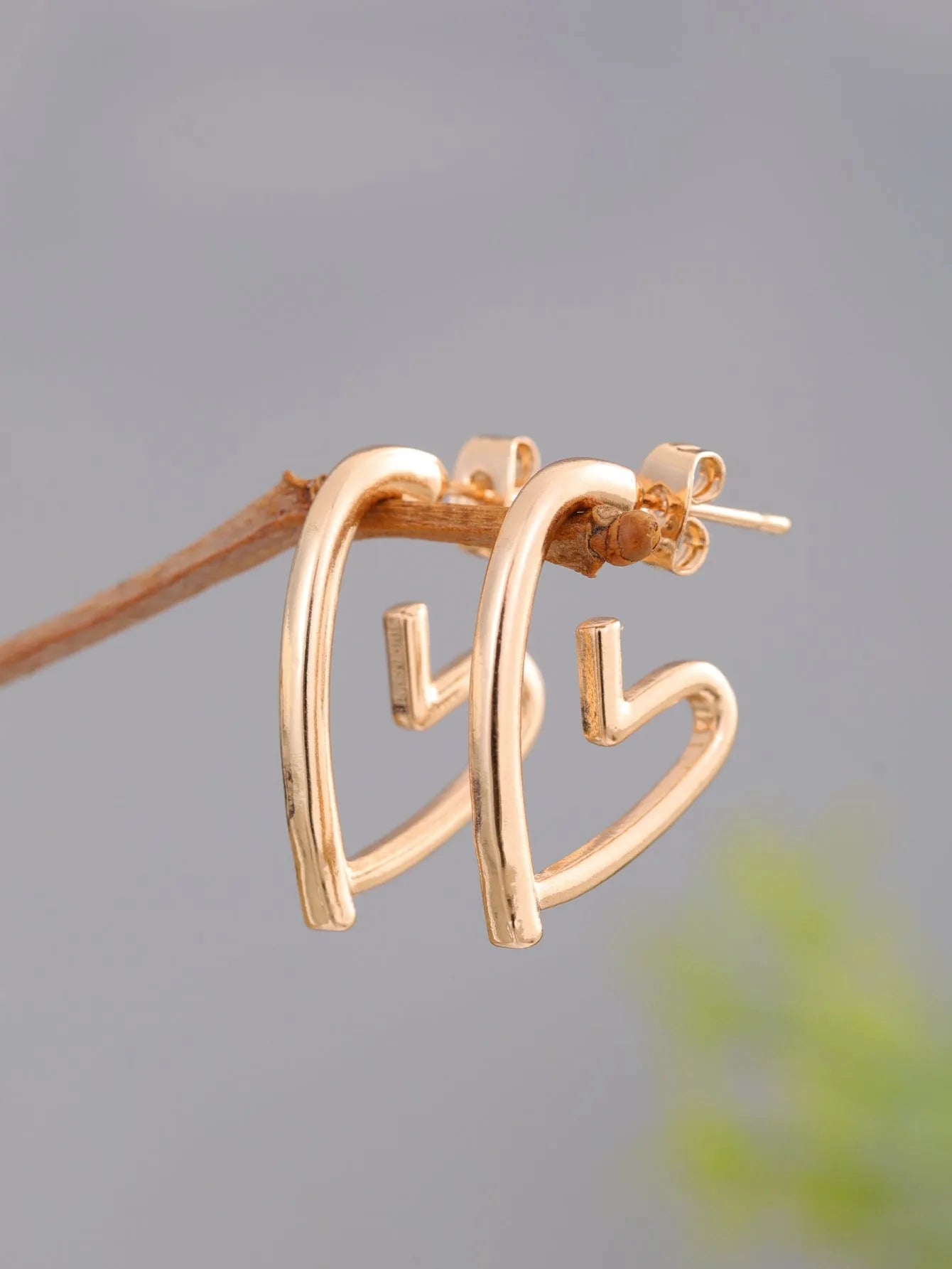 Simple cold style love earrings for women in gold colour metal stud earrings