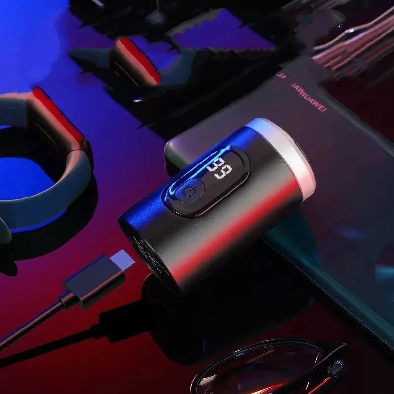 Black portable USB rechargeable shaver with LED display on a clean background.