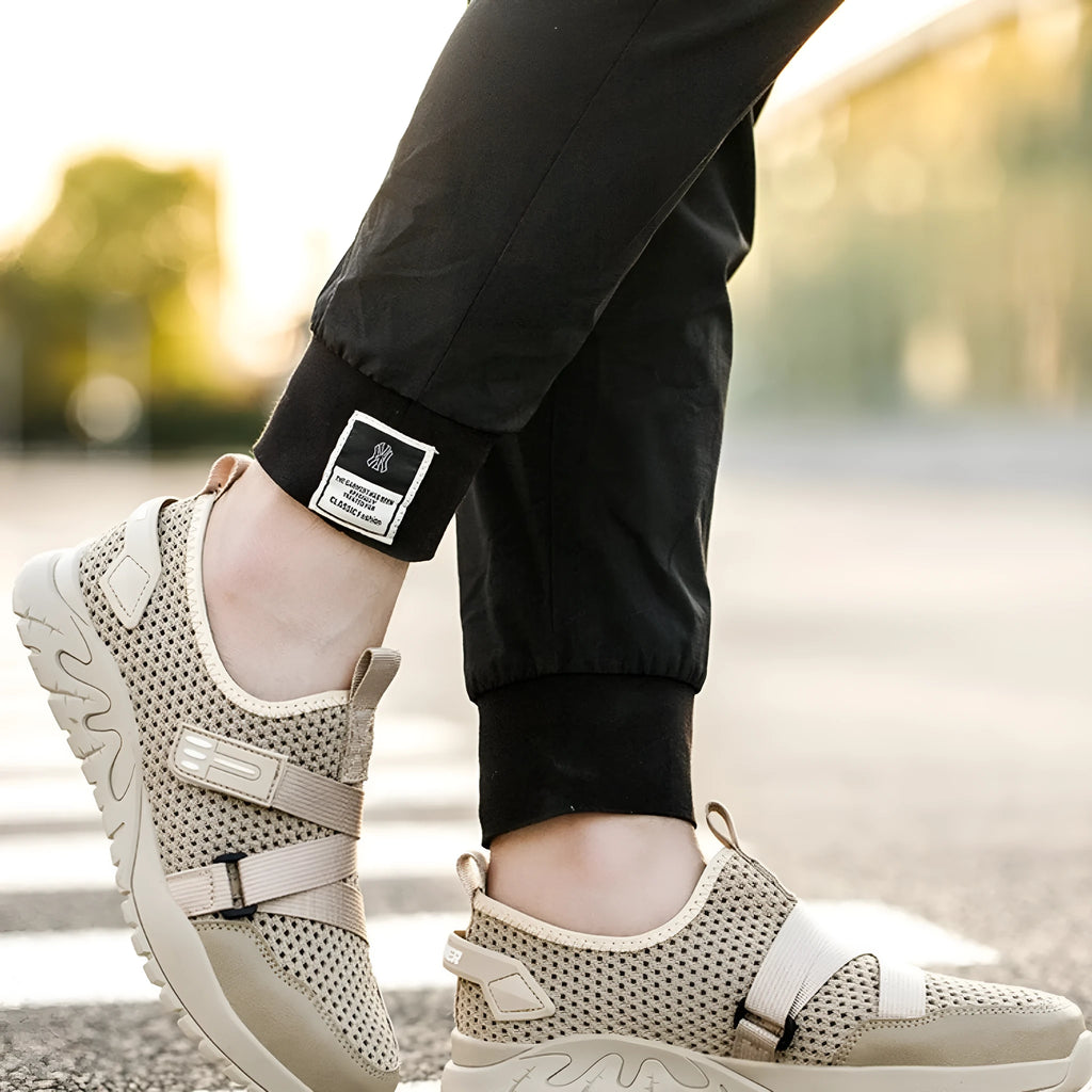 Men's grey anti-smash and anti-puncture safety shoes with a flying woven upper and rubber sole.