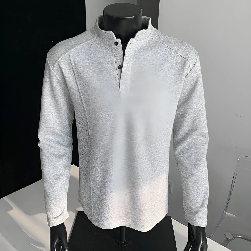Men's black asymmetric patchwork long sleeve polo shirt with a stand-up collar, laid flat.