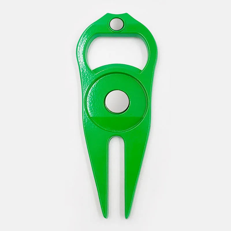 Black zinc alloy golf ball yoke and bottle opener tool on a putting green.