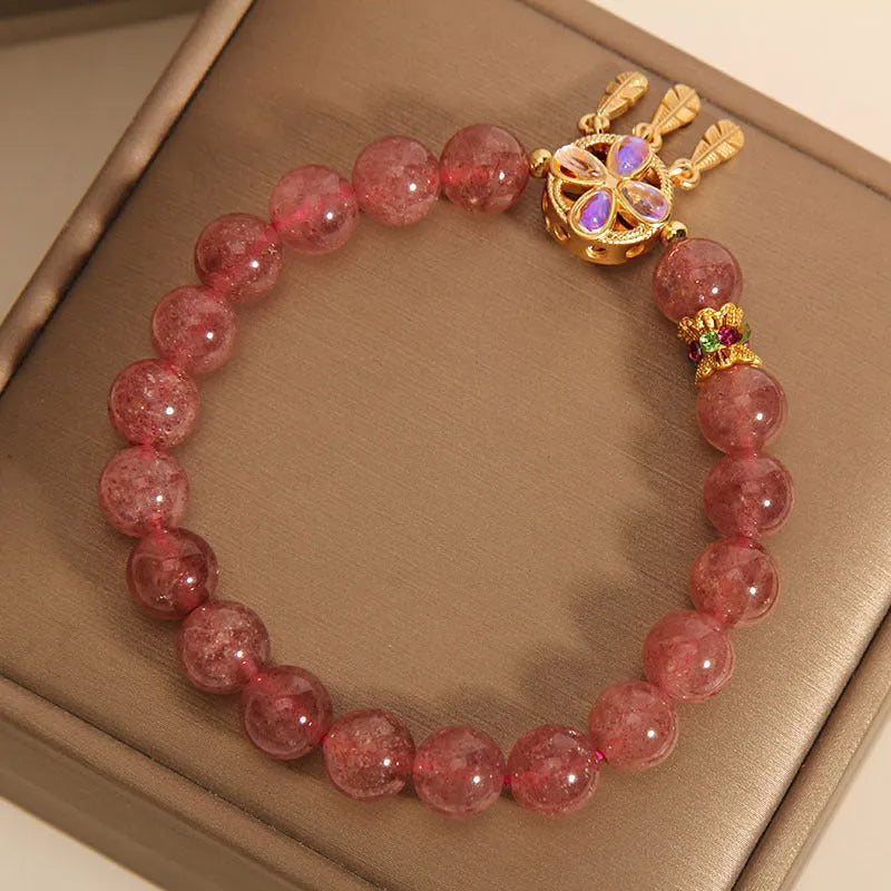 Women's adjustable strawberry quartz bracelet with four leaf dream catcher ball pendant and crystal beads