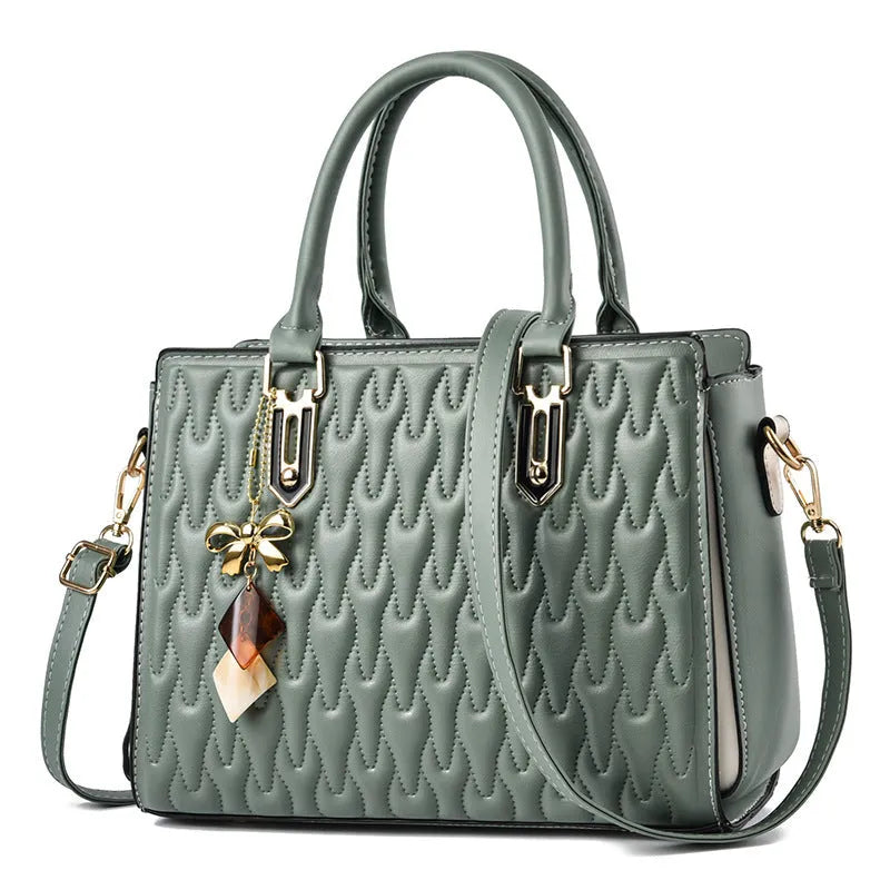 Women's polyester shoulder messenger bag with a front PU pocket in green, showing its structured shape and strap.